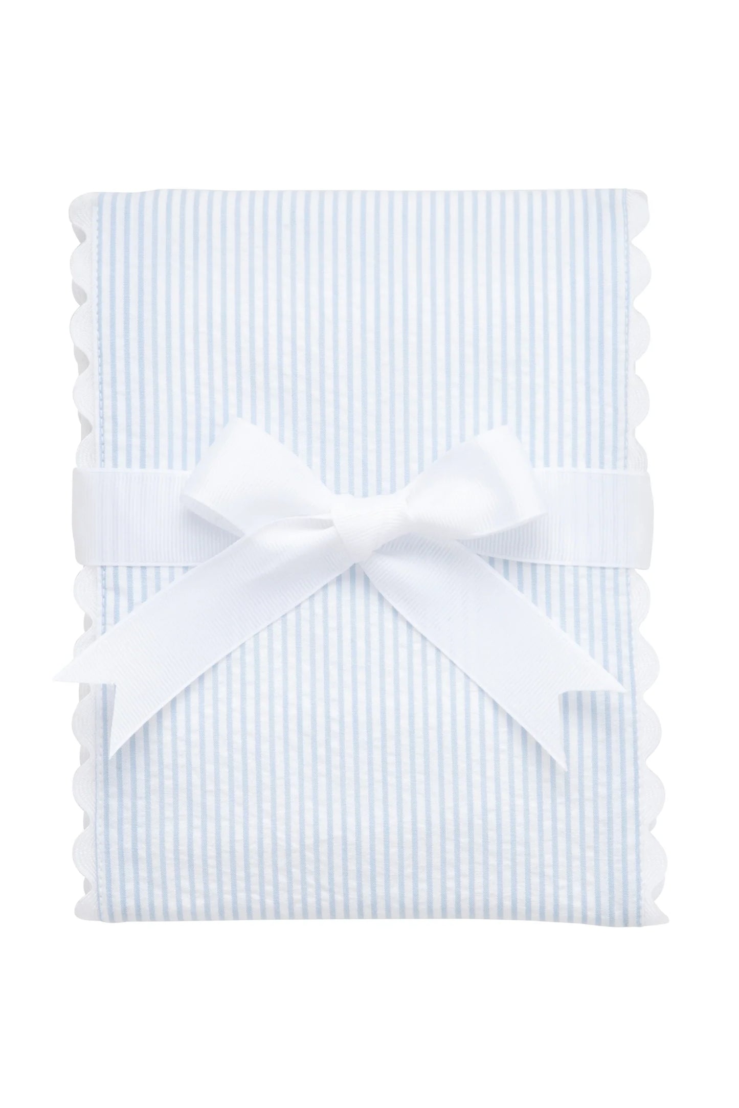 White burp cloth trimmed in light-blue seersucker stripe with ric rac edge, folded and tied with a white bow against a white background.