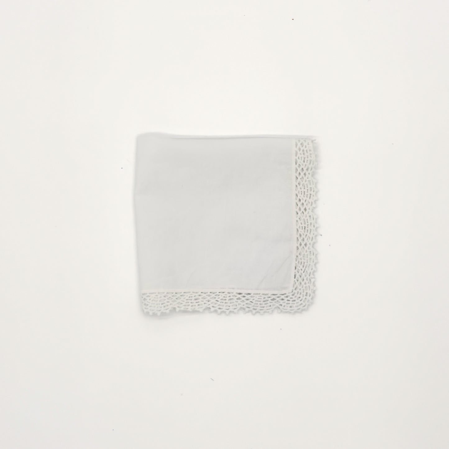 White cotton handkerchief with crochet lace edging, 12" x 12", folded into a square against a white background.