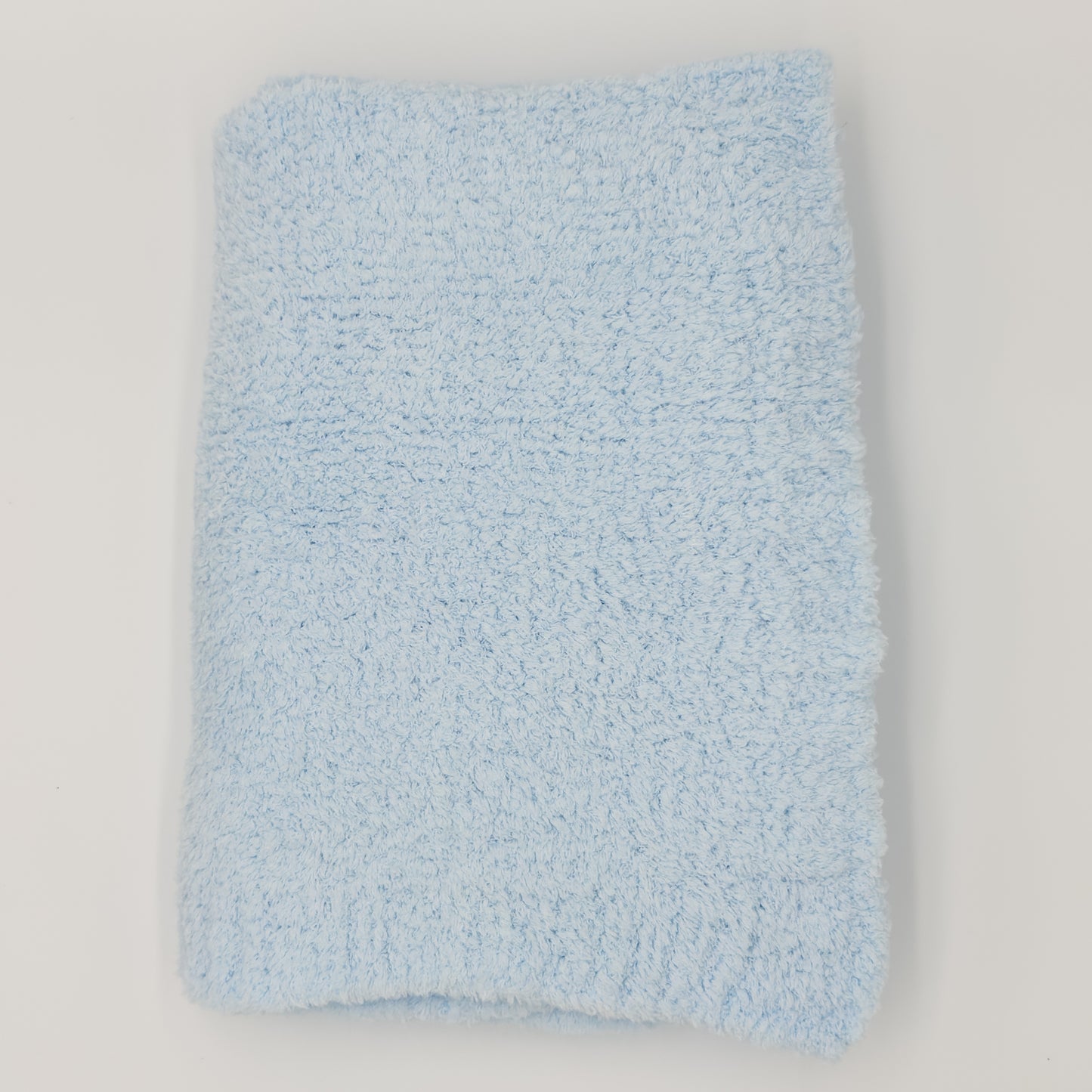 Light-blue chenille baby blanket with plush pile, folded on white. Add custom embroidery to the lower right corner of the blanket.