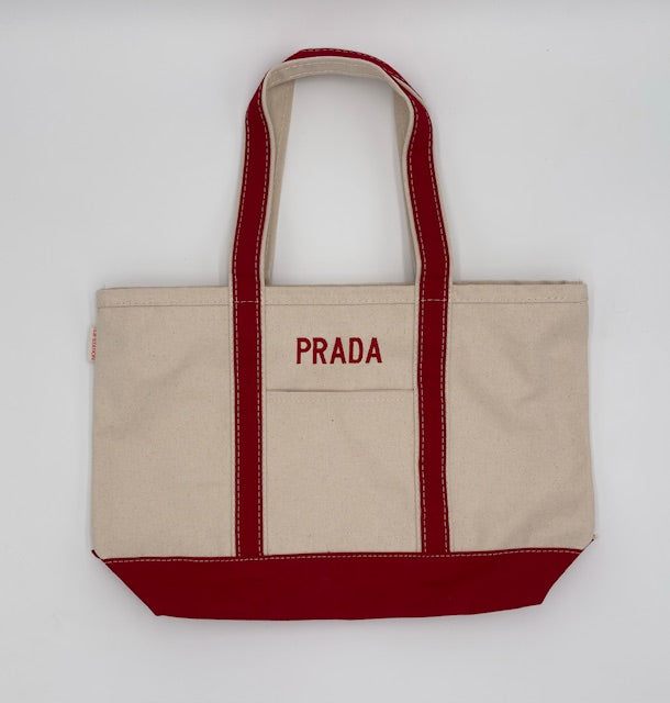 Natural and red canvas boat tote embroidered ‘PRADA’ in red.