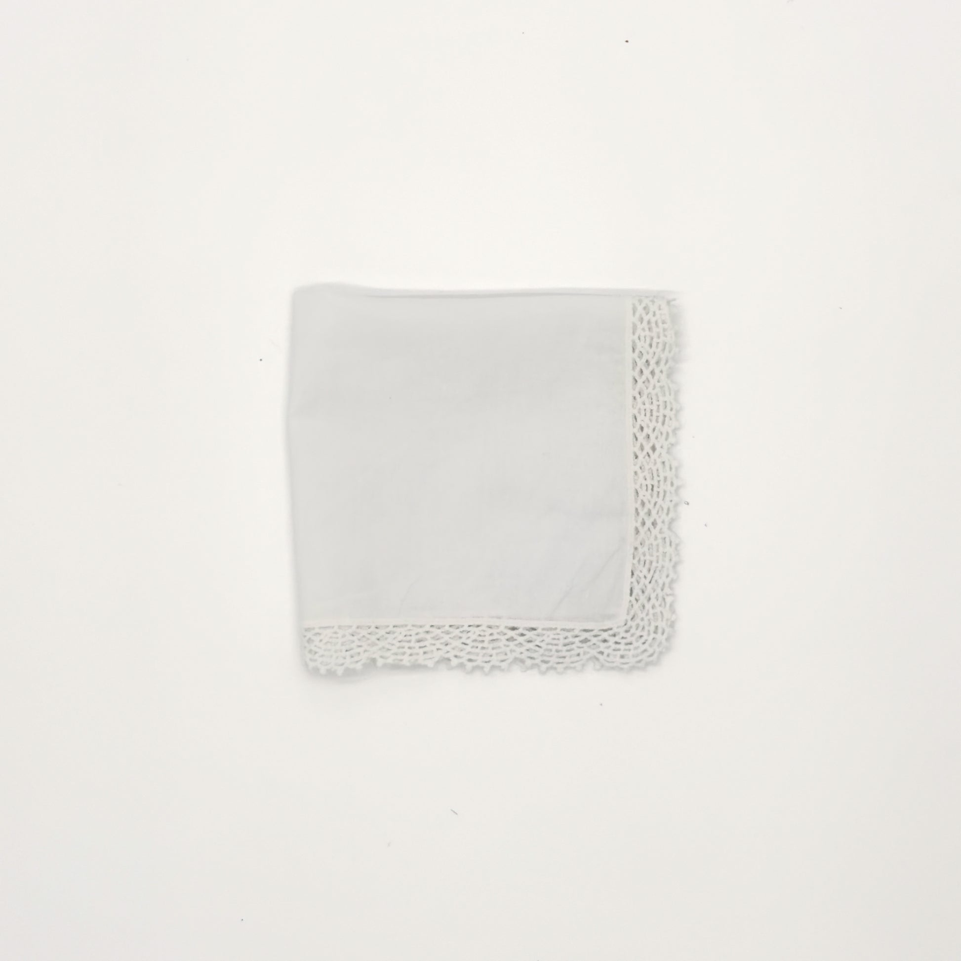 White cotton handkerchief with crochet lace edging, 12" x 12", folded into a square against a white background.