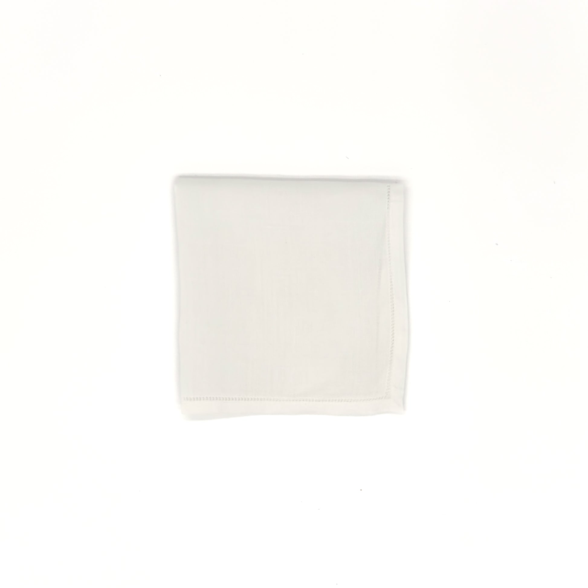 White cotton men’s handkerchief with hemstitch border, 20″ square, folded into a square.