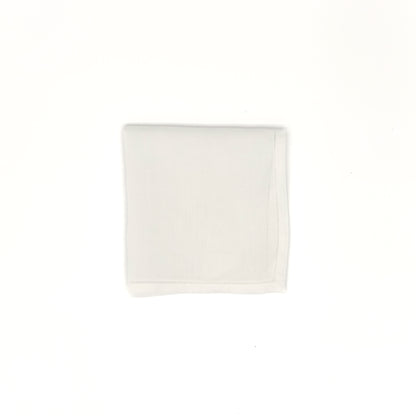 White cotton men’s handkerchief with hemstitch border, 20″ square, folded into a square.