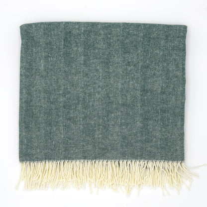 Sage green herringbone throw with ivory fringe, soft woven texture, folded. Add custom embroidery along the bottom-center of the blanket.