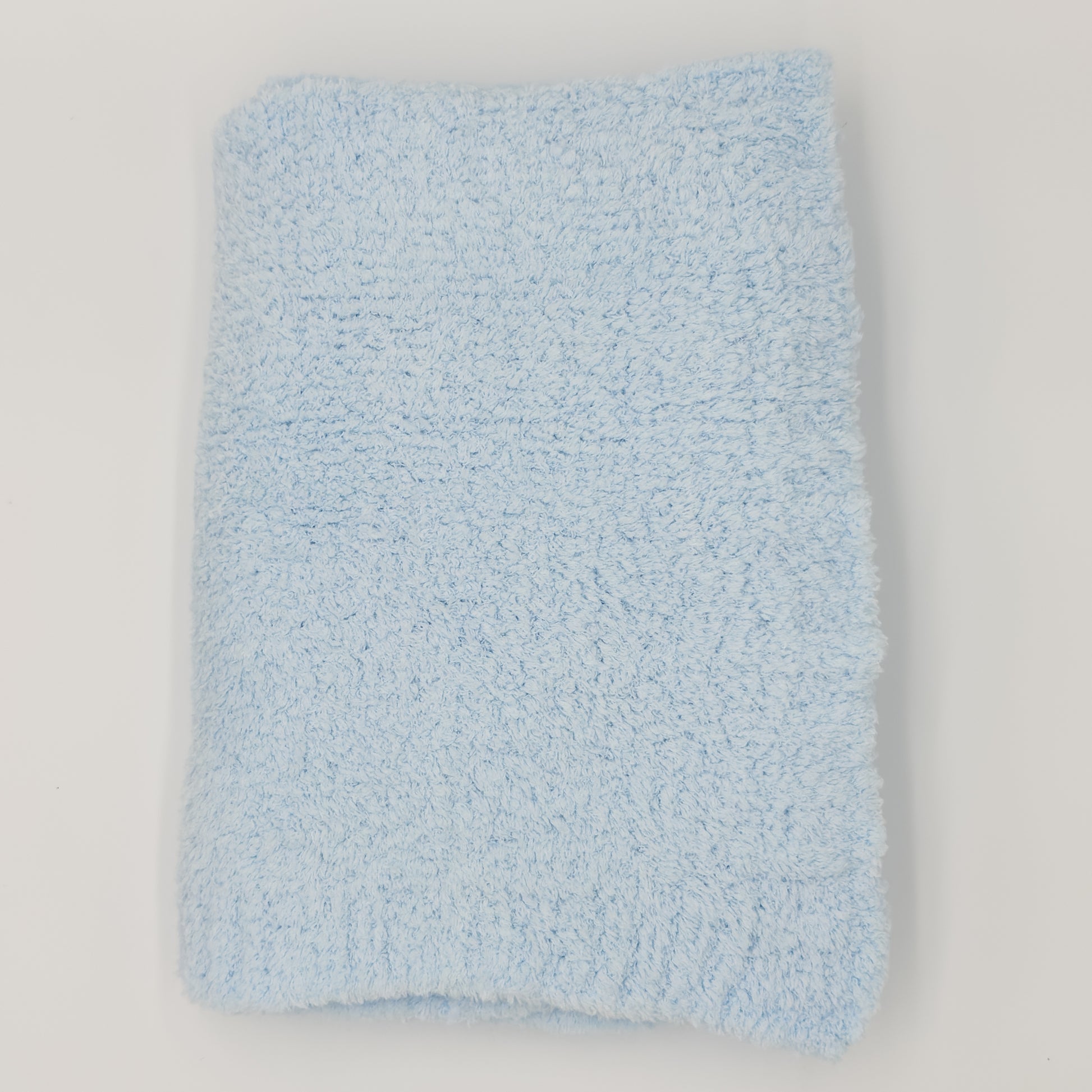 Light-blue chenille baby blanket with plush pile, folded on white. Add custom embroidery to the lower right corner of the blanket.