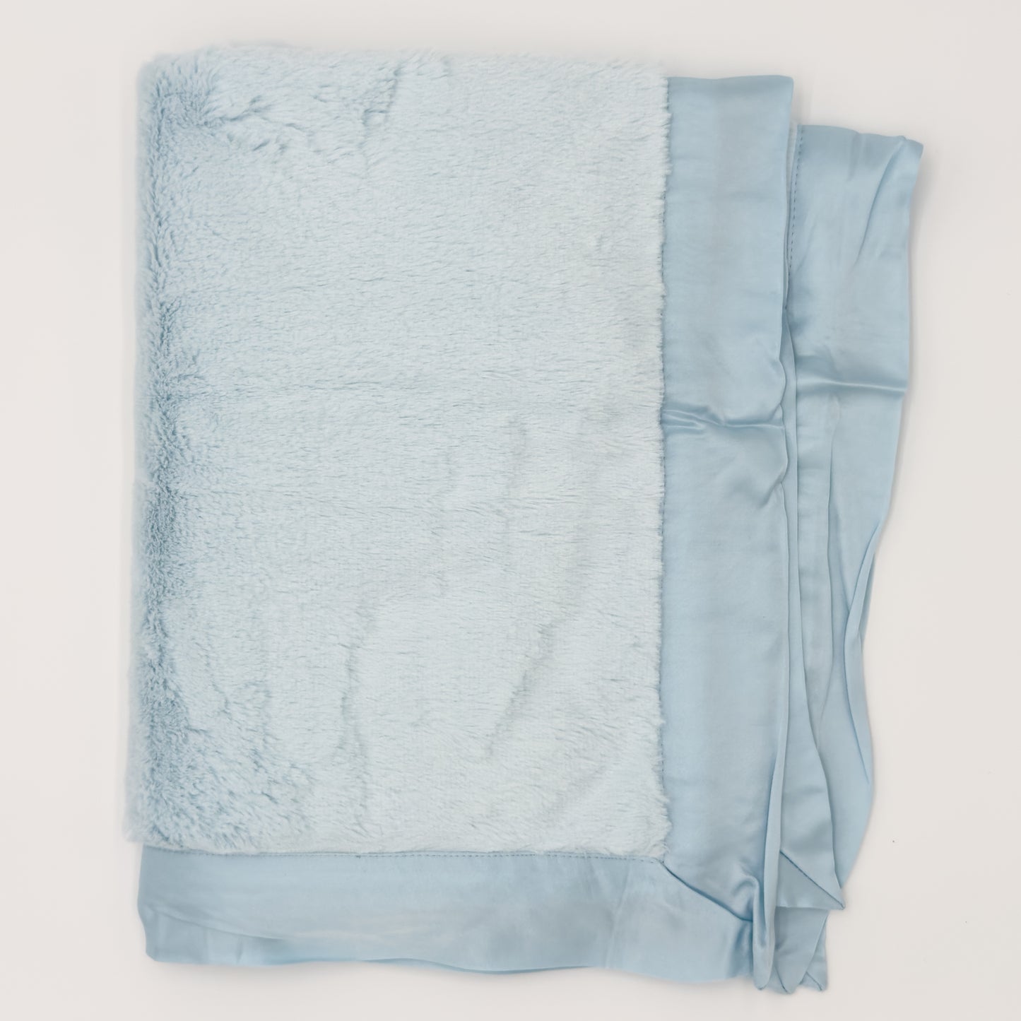 Light-blue faux-fur baby blanket with glossy satin border, shown folded. Add custom embroidery to the lower right corner of the blanket.