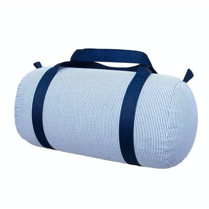 Cylindrical kids’ duffel in navy-and-white seersucker with solid navy straps, shown on white. Add custom embroidery centered along the length of the bag.