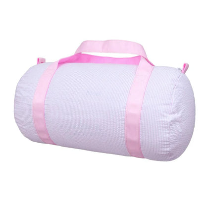 Cylindrical kids’ duffel in pale-pink seersucker with matching pink straps, shown on white. Add custom embroidery centered along the length of the bag.